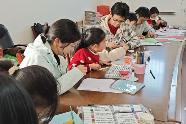 图二 志愿者跟孩子们完成他们的作品.jpg